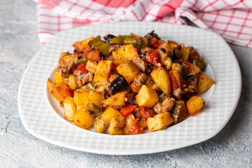 Turkish Kebab eggplant, potatoes, pepper and piece of meat. Vegetables kebab. Turkish cuisine tops view - Turkish name; Sebzeli Koz Kebab or sebze kebabi