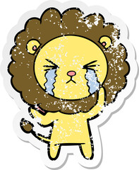 distressed sticker of a cartoon crying lion