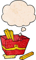 cartoon box of fries with thought bubble in grunge texture style
