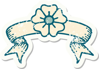worn old sticker with banner of a flower