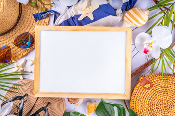 Tropical vacation beach getaway background. Flat lay with summer accessories, sunglasses, sun hat, sandals, starfish, palm leaves, top view on white background with copy space