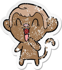 distressed sticker of a cartoon laughing monkey