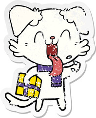 distressed sticker of a cartoon panting dog with present