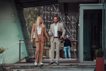 Obraz na płótnie Canvas Modern business couple after a long day's work, walking together towards the comfort of their home, embodying the perfect blend of professional success and personal contentment.