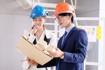 Engineers meeting to look at the drawings to design the structure of the house.