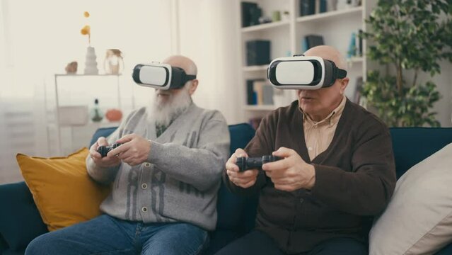 Senior friends playing video game in VR glasses, virtual reality experience