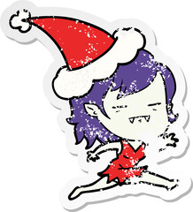 hand drawn distressed sticker cartoon of a undead vampire girl wearing santa hat