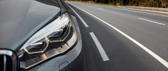 Obraz na płótnie Canvas Modern car headlight close up view on the highway