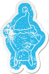 quirky cartoon distressed sticker of a bear wearing santa hat