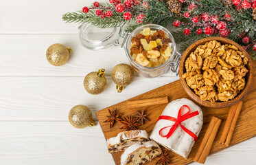 Christmas stollen on wooden background. Traditional Christmas festive pastry dessert. Stollen for Christmas.Christmas fruit cake, pudding on a white plate.Traditional German Christmas pastry.