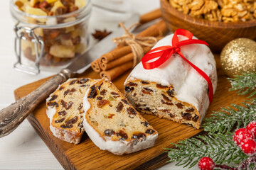 Christmas stollen on wooden background. Traditional Christmas festive pastry dessert. Stollen for Christmas.Christmas fruit cake, pudding on a white plate.Traditional German Christmas pastry.
