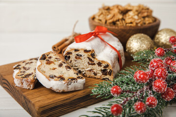 Christmas stollen on wooden background. Traditional Christmas festive pastry dessert. Stollen for Christmas.Christmas fruit cake, pudding on a white plate.Traditional German Christmas pastry.