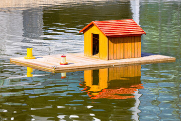 floating house for birds on the pond.