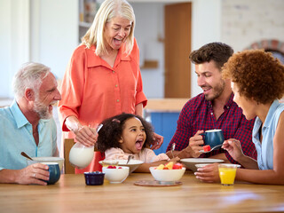Multi-Generation Family At Home Enjoying Breakfast Together