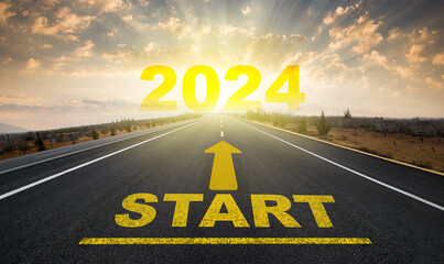 Starting the new year. Start line on asphalt road and 2024 going arrow on horizon. New year concept.