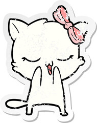 distressed sticker of a cartoon cat with bow on head