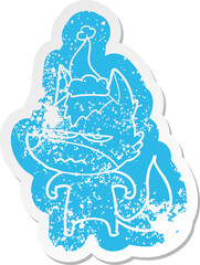 quirky cartoon distressed sticker of a annoyed wolf wearing santa hat