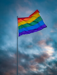 Pride flag with dramatic cloudy sunset sky, Castro District, San Francisco, California, United States. Photo taken in July 2023.