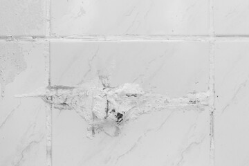 Old gray white surface broken tile damage floor repair background, renovation concept