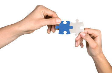 Closeup on Hands Combining Puzzle Pieces Together