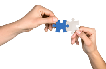 Closeup on Hands Combining Puzzle Pieces Together