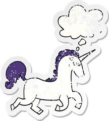 cartoon unicorn with thought bubble as a distressed worn sticker