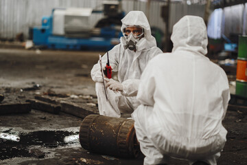 chemical specialist wear safety uniform and gas mask inspecting chemical leak in industry factory