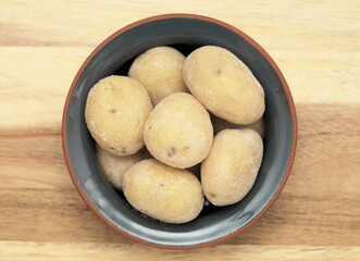 Cuisine of Canary Islands - papas arrugadas, wrinkly potatoes, in a small ceramic bowl
