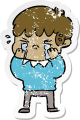 Fototapeta premium distressed sticker of a cartoon boy crying