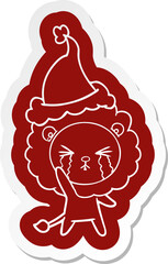 quirky cartoon  sticker of a crying lion wearing santa hat