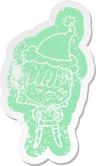 annoyed quirky cartoon distressed sticker of a girl wearing santa hat
