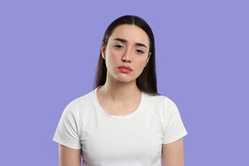 Fototapeta premium Tired young woman on purple background. Insomnia problem