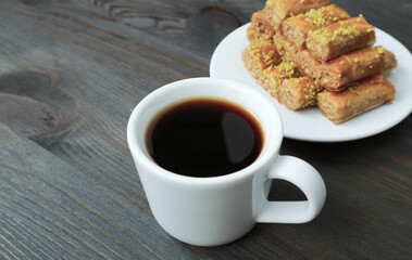 Closeup of a Cup of Turkish Coffee with Blurry Baklava Pastries in the Backdrop