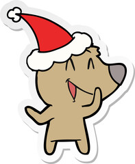 laughing bear hand drawn sticker cartoon of a wearing santa hat