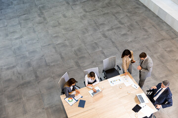 Fototapeta premium Aerial view at young startup team working in the office