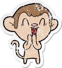 distressed sticker of a cartoon laughing monkey