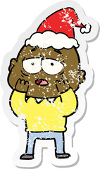 hand drawn distressed sticker cartoon of a tired bald man wearing santa hat