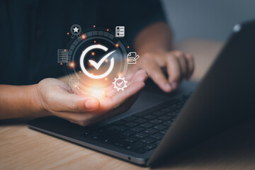 Businessman hand showing checked icon, concept Quality Assurance(QA) and Quality Control (QC) certification standards in a product or service guarantee