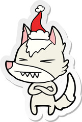 angry wolf hand drawn sticker cartoon of a wearing santa hat