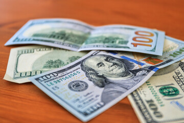 100 dollar bills on the table at home