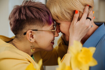 Generational Bond: Non-Binary Daughter , Mother Embrace in Birthday Celebration
