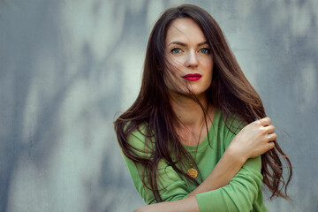 Portrait of young woman with beautiful green eyes and brunette hair