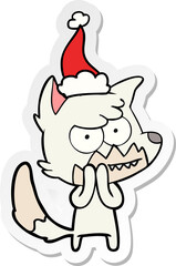 hand drawn sticker cartoon of a grinning fox wearing santa hat