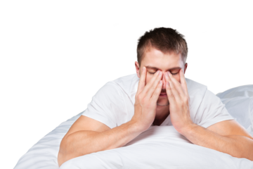 Upset male because of lack of sleep lying in the bed