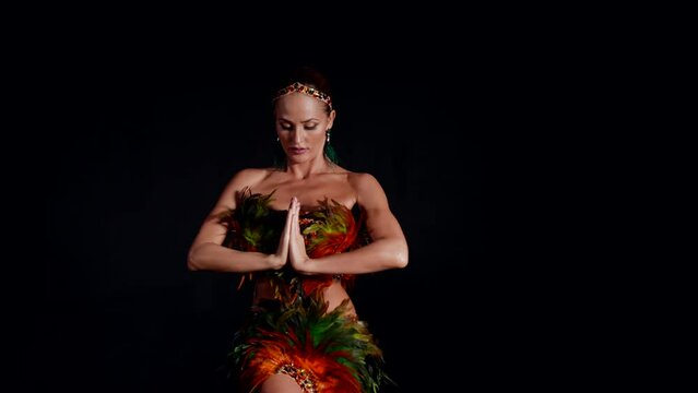 professional female dancer is performing extravagant dance in dark rehearsal room, portrait