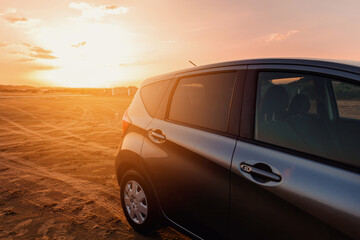 Fototapeta na wymiar Beautiful sunset and modern Car Off-roading near the Beach