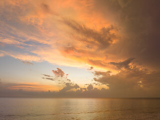 aerial view amazing cloud in colorful sky at sunset above the ocean..the sea water reflected from the sky..Majestic sunset landscape Amazing light of nature..beautiful sunset cloudscape background..