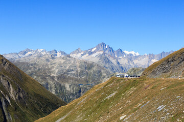 Fototapeta na wymiar Panorama view with mountain Finsteraarhorn and Furka Pass road in the Swiss Alps, Switzerland