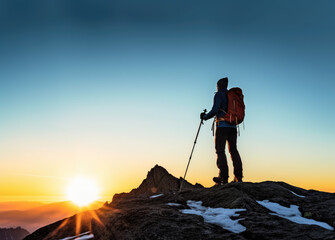 Silhouette of a man with trekking poles looking on a mountain at sunset. Adventure, Hiking and awe-inspiring landscapes concept. AI Generative