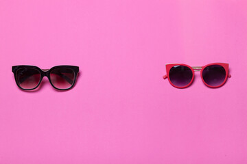 luxury fashionable sunglasses on pink and purple background, flatlay top view